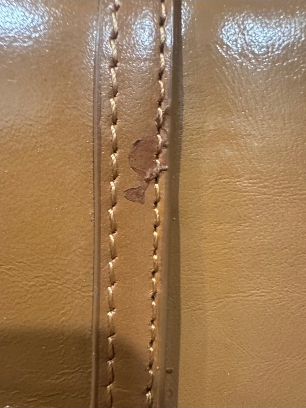 The Find Classic Tan Leather Weekender Travel Bag with Gold Hardware Buckle.